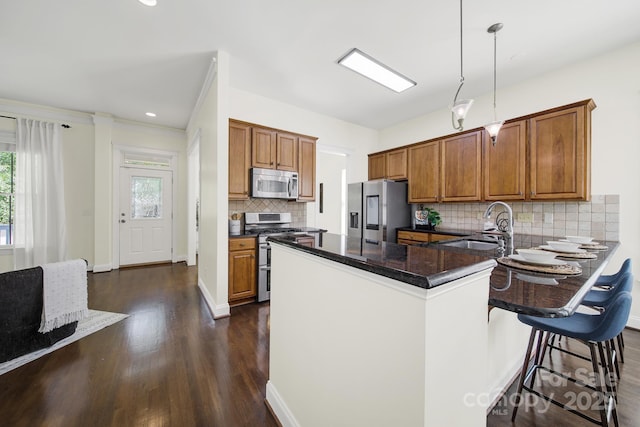 1855 Second Baxter Xing, Fort Mill, SC 29708 - kitchen featuring stainless steel appliances, brown cabinetry, dark wood-style floors, a peninsula, and tasteful backsplash