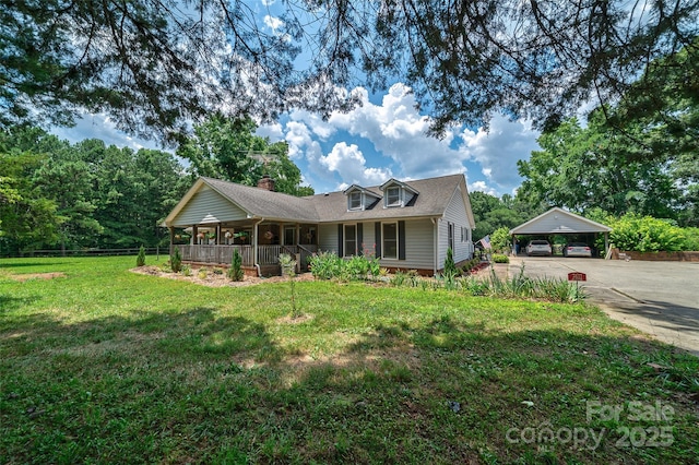 7411 Davis Rd, Waxhaw, NC 28173 - view of front facade with a detached carport, concrete driveway, a porch, roof with shingles, and a chimney