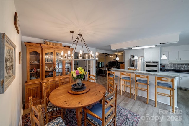 7411 Davis Rd, Waxhaw, NC 28173 - dining space featuring a chandelier and light wood-style floors