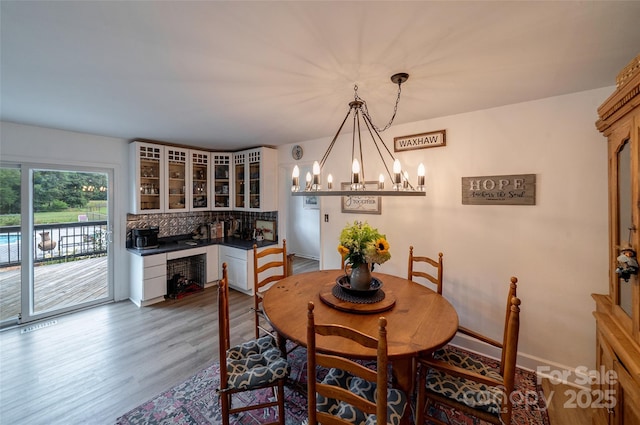 7411 Davis Rd, Waxhaw, NC 28173 - dining space with a chandelier and dark wood-style flooring