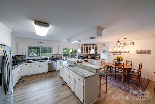 7411 Davis Rd, Waxhaw, NC 28173 - kitchen with stainless steel appliances, decorative backsplash, healthy amount of natural light, and a chandelier