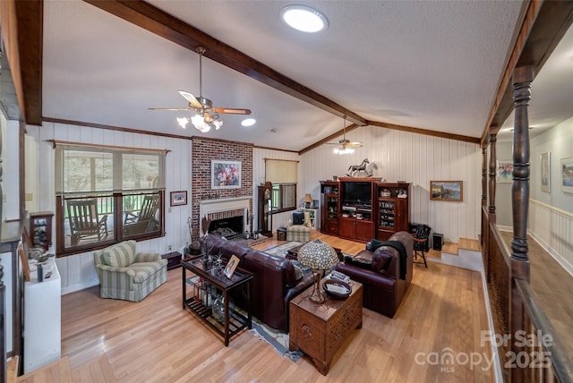 7411 Davis Rd, Waxhaw, NC 28173 - living area with ceiling fan, wood finished floors, a brick fireplace, and crown molding