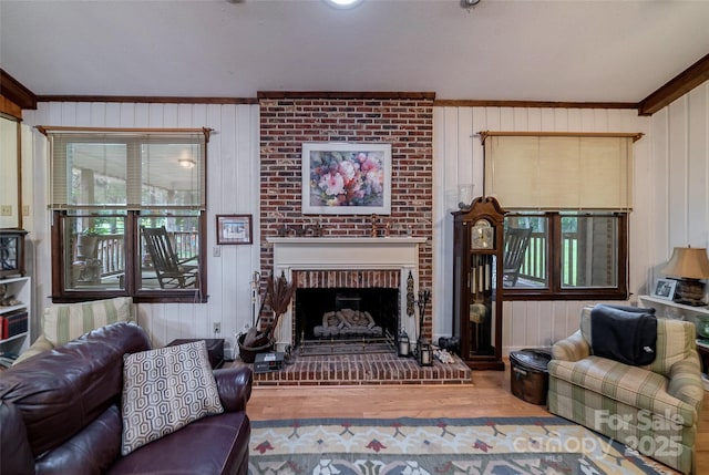 7411 Davis Rd, Waxhaw, NC 28173 - living area with ornamental molding, plenty of natural light, wood finished floors, a brick fireplace, and wooden walls