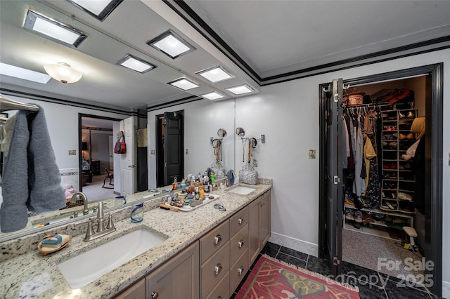 7411 Davis Rd, Waxhaw, NC 28173 - bathroom featuring double vanity, a spacious closet, and tile patterned floors