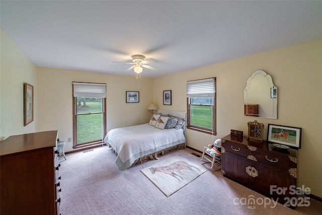 7411 Davis Rd, Waxhaw, NC 28173 - carpeted bedroom featuring multiple windows and ceiling fan