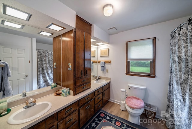 7411 Davis Rd, Waxhaw, NC 28173 - full bath featuring wood finished floors and double vanity