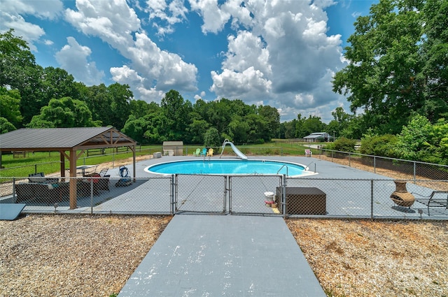 7411 Davis Rd, Waxhaw, NC 28173 - view of swimming pool featuring a water slide, a gate, view of wooded area, and a gazebo