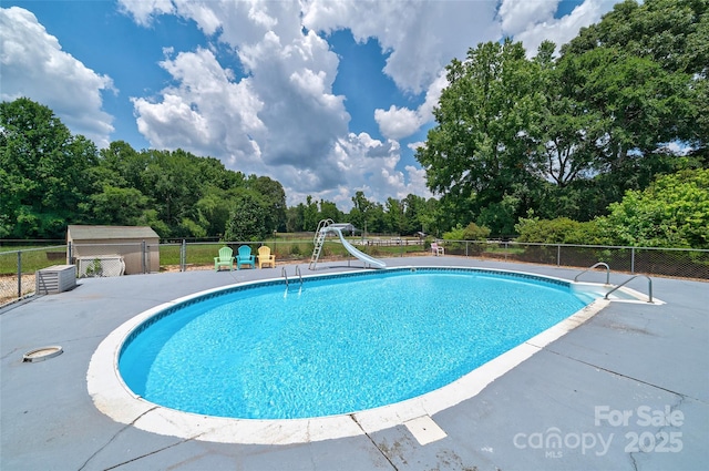 7411 Davis Rd, Waxhaw, NC 28173 - view of swimming pool featuring a water slide, a patio, and view of wooded area
