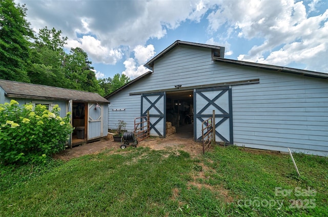 7411 Davis Rd, Waxhaw, NC 28173 - rear view of house featuring an outbuilding and a yard