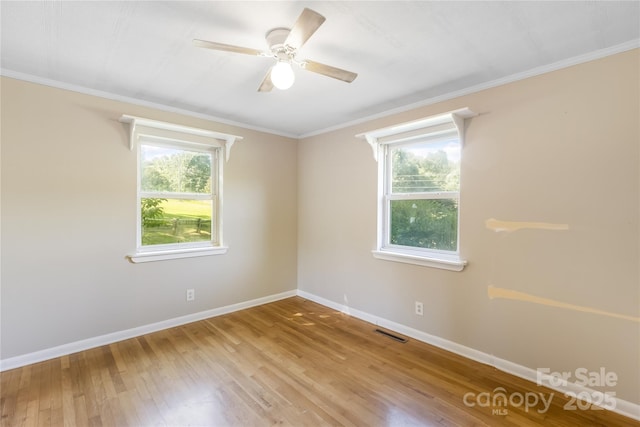 735 Edmiston Rd, Mount Ulla, NC 28125 - unfurnished room with healthy amount of natural light, hardwood / wood-style floors, a ceiling fan, and crown molding