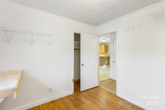 735 Edmiston Rd, Mount Ulla, NC 28125 - unfurnished bedroom with wood finished floors, crown molding, and a closet