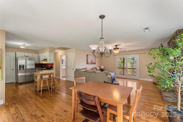 4 Northview Ln, Weaverville, NC 28787 - dining space featuring light wood finished floors, a chandelier, and a ceiling fan