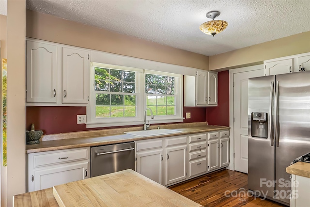 4 Northview Ln, Weaverville, NC 28787 - kitchen with stainless steel appliances, a textured ceiling, white cabinets, dark wood-style floors, and wooden counters