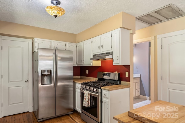 4 Northview Ln, Weaverville, NC 28787 - kitchen with stainless steel appliances, under cabinet range hood, white cabinets, light wood-style flooring, and light countertops