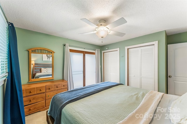 4 Northview Ln, Weaverville, NC 28787 - carpeted bedroom featuring multiple closets, a ceiling fan, and a textured ceiling