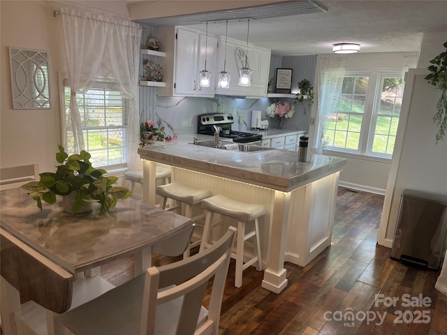 69 Devlin St, Canton, NC 28716 - kitchen with electric range, white cabinetry, dark wood-style floors, and light countertops