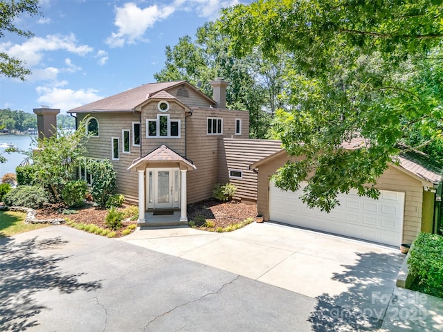 5 Hidden Cove Ln, Clover, SC 29710 - view of front of house with a garage, driveway, a chimney, and a water view