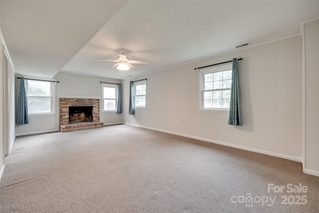 810 Applegate Ct, Gastonia, NC 28054 - unfurnished living room featuring carpet floors, ceiling fan, plenty of natural light, a brick fireplace, and ornamental molding