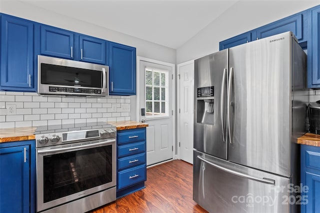 110 Bost Cir, Rockwell, NC 28138 - kitchen featuring appliances with stainless steel finishes, wood counters, blue cabinetry, vaulted ceiling, and tasteful backsplash