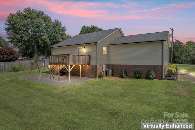 110 Bost Cir, Rockwell, NC 28138 - back of property at dusk featuring a deck, a patio area, and brick siding