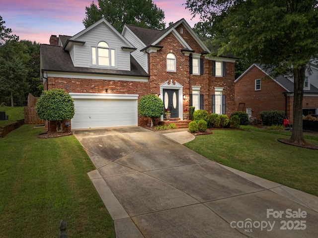 4108 Deerfield Dr NW, Concord, NC 28027 - view of front of home with driveway, an attached garage, brick siding, a front yard, and roof with shingles