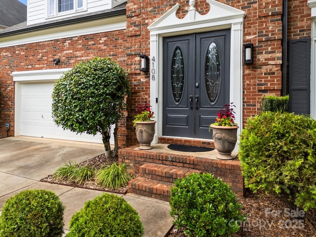 4108 Deerfield Dr NW, Concord, NC 28027 - property entrance with brick siding, concrete driveway, french doors, and a garage