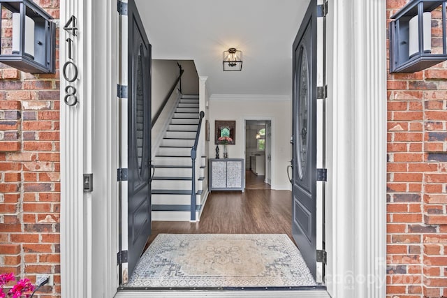 4108 Deerfield Dr NW, Concord, NC 28027 - foyer with stairway, dark wood-style flooring, crown molding, and brick wall