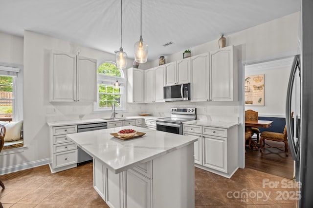 4108 Deerfield Dr NW, Concord, NC 28027 - kitchen with appliances with stainless steel finishes, a kitchen island, and white cabinets