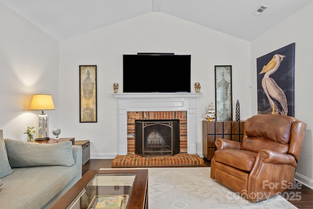 4108 Deerfield Dr NW, Concord, NC 28027 - living area with lofted ceiling, wood finished floors, and a brick fireplace