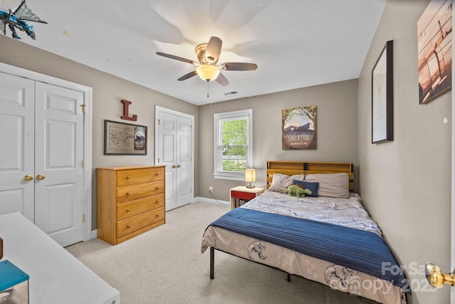 4108 Deerfield Dr NW, Concord, NC 28027 - bedroom featuring light carpet, ceiling fan, and two closets