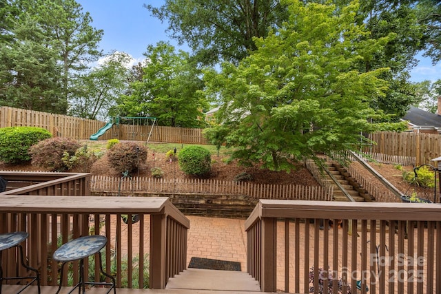 4108 Deerfield Dr NW, Concord, NC 28027 - wooden deck with stairway, a playground, and a fenced backyard