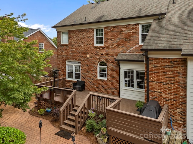 4108 Deerfield Dr NW, Concord, NC 28027 - back of property featuring brick siding, a deck, and a shingled roof