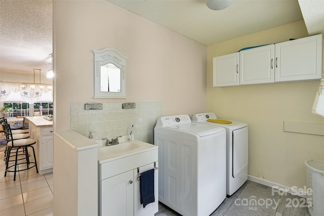 209 Camellia Way, Hendersonville, NC 28739 - laundry room with independent washer and dryer, a textured ceiling, light tile patterned floors, a chandelier, and cabinet space
