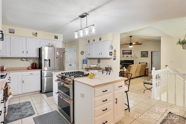 209 Camellia Way, Hendersonville, NC 28739 - kitchen featuring appliances with stainless steel finishes, ceiling fan, light tile patterned floors, a kitchen island, and light countertops