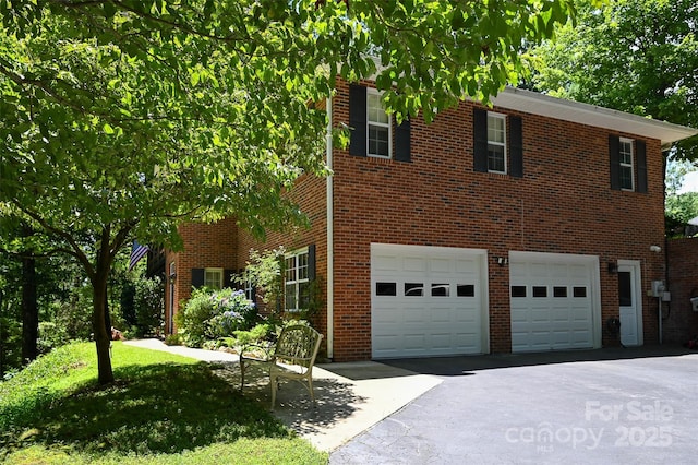 209 Camellia Way, Hendersonville, NC 28739 - view of front of house featuring driveway, a garage, and brick siding