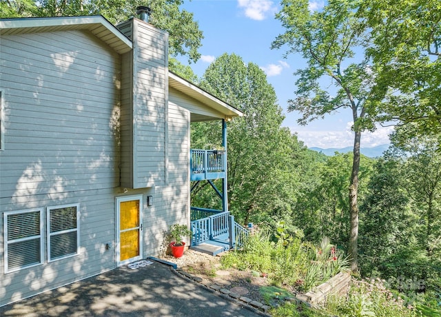 208 Tuckaway Rd, Waynesville, NC 28785 - view of side of home featuring a chimney and a balcony