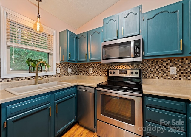 208 Tuckaway Rd, Waynesville, NC 28785 - kitchen with appliances with stainless steel finishes, vaulted ceiling, light countertops, decorative backsplash, and pendant lighting