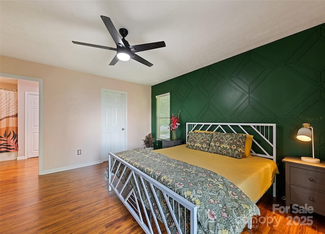 208 Tuckaway Rd, Waynesville, NC 28785 - bedroom with wood finished floors, a ceiling fan, and an accent wall