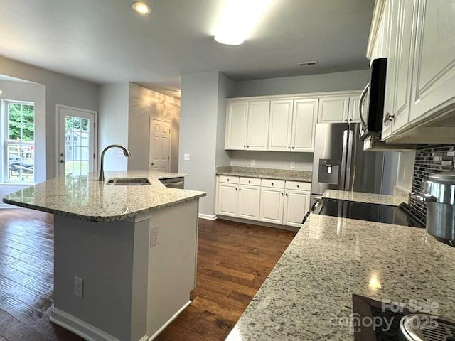 7563 Sedgebrook Dr W, Stanley, NC 28164 - kitchen featuring appliances with stainless steel finishes, dark wood finished floors, light stone counters, white cabinetry, and recessed lighting