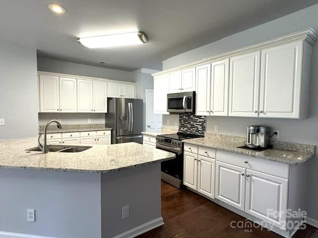 7563 Sedgebrook Dr W, Stanley, NC 28164 - kitchen with appliances with stainless steel finishes, light stone counters, white cabinets, dark wood-type flooring, and recessed lighting