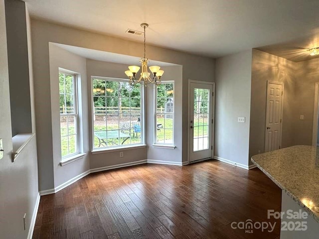7563 Sedgebrook Dr W, Stanley, NC 28164 - unfurnished dining area with dark wood-style flooring and a chandelier