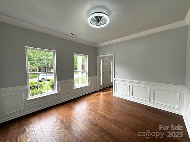 7563 Sedgebrook Dr W, Stanley, NC 28164 - spare room featuring ornamental molding, wainscoting, dark wood-style flooring, and a decorative wall