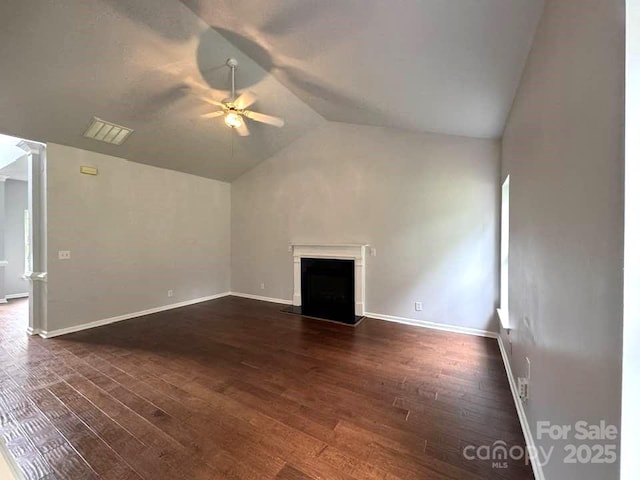 7563 Sedgebrook Dr W, Stanley, NC 28164 - unfurnished living room with a ceiling fan, lofted ceiling, dark wood-style floors, a fireplace with raised hearth, and decorative columns