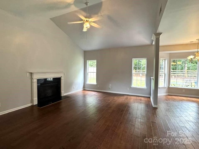 7563 Sedgebrook Dr W, Stanley, NC 28164 - unfurnished living room featuring a ceiling fan, dark wood-style flooring, a fireplace, high vaulted ceiling, and a chandelier