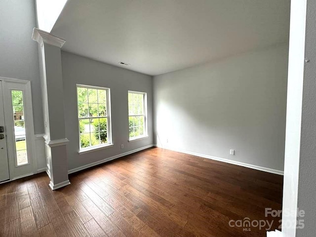 7563 Sedgebrook Dr W, Stanley, NC 28164 - empty room with ornate columns and dark wood-style flooring