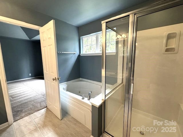 7563 Sedgebrook Dr W, Stanley, NC 28164 - full bathroom with a shower stall, a jetted tub, and tile patterned floors