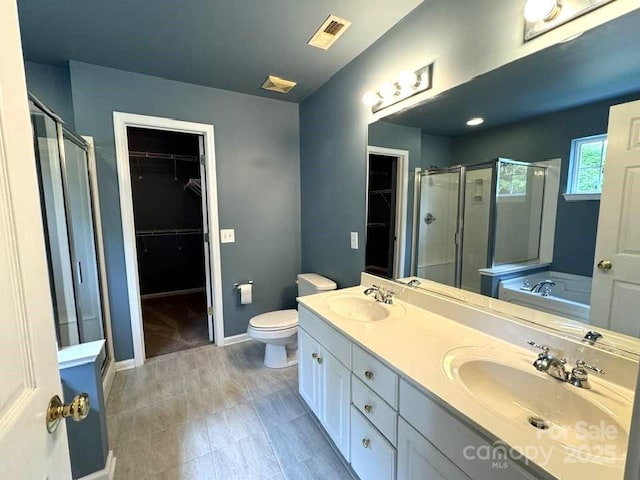 7563 Sedgebrook Dr W, Stanley, NC 28164 - bathroom featuring a shower stall, double vanity, a walk in closet, and a bath