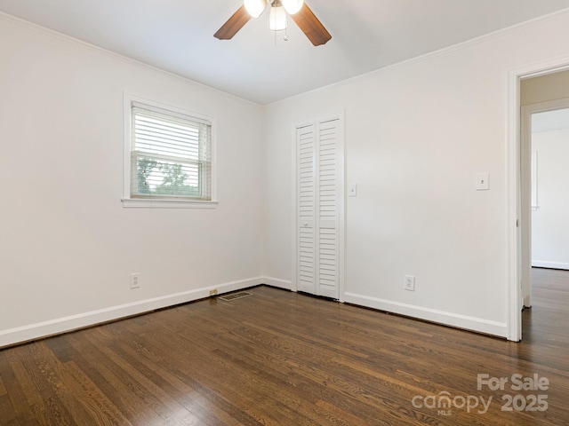 5123 Glenham Dr, Charlotte, NC 28210 - unfurnished bedroom featuring dark wood-style flooring, crown molding, a closet, and a ceiling fan