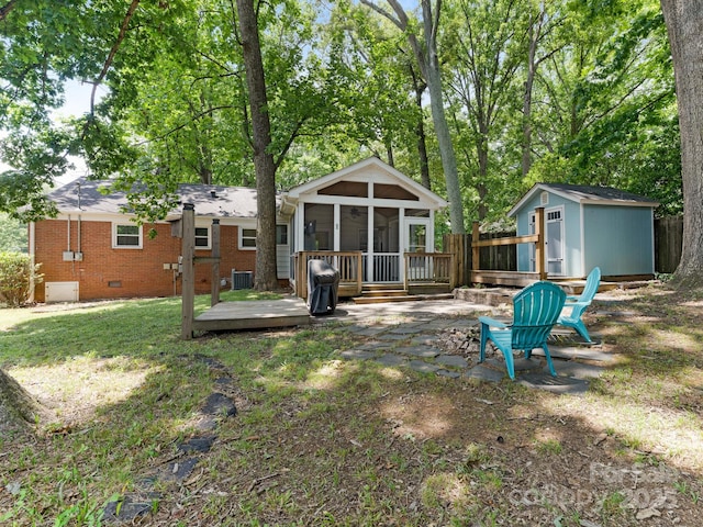 5123 Glenham Dr, Charlotte, NC 28210 - back of house featuring a sunroom, crawl space, a wooden deck, a storage shed, and brick siding