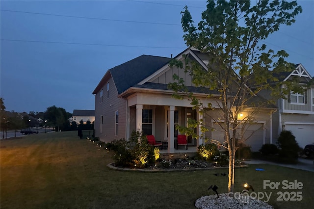 2026 Union Grove Ln, Indian Trail, NC 28079 - view of front of house featuring covered porch, a front yard, an attached garage, and board and batten siding